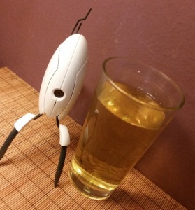 Glass of Boonville Bite Hard cider & small Portal turret bot